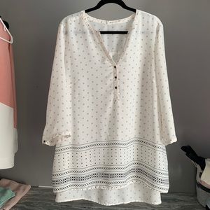 Plus size cream blouse with cute black pattern.